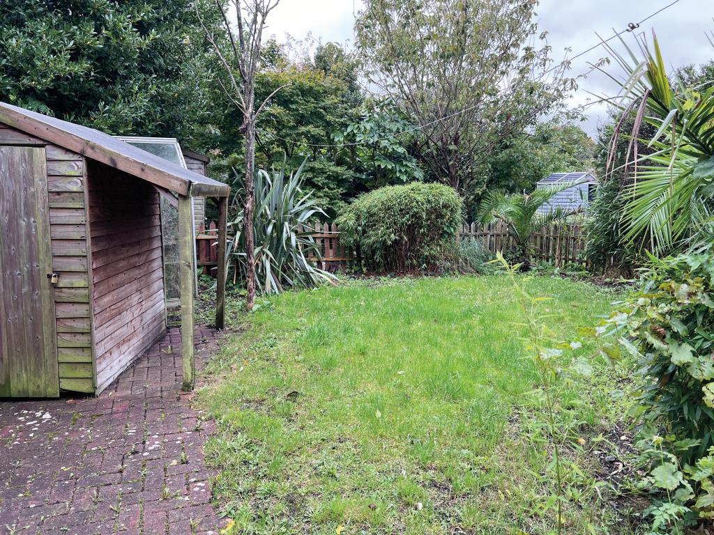 Lot: 65 - TWO-BEDROOM COTTAGE FOR INVESTMENT OR OCCUPATION - Garden with grass lawn and shed